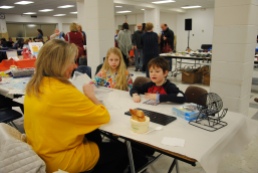 Lion's Club volunteer playing bingo at the Kids' Table