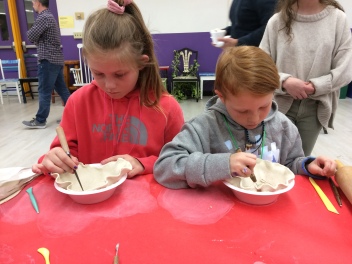 Young potters make a clay bowl.